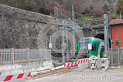 Closed railway crossing and train in tunnel. Riola, Bologna, Emilia-Romagna, Italy Stock Photo