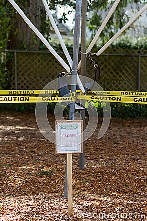 Closed sign in front of tied up swing set Stock Photo