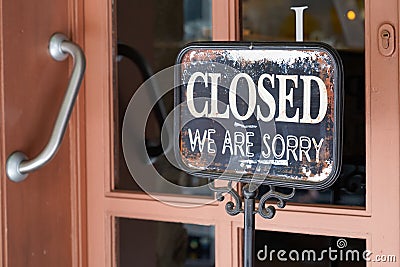 Closed we are sorry text steel board windows door vintage shop sign close store Stock Photo