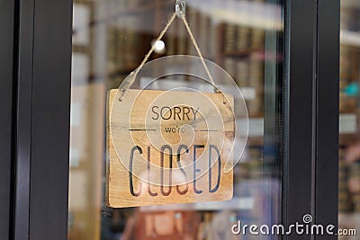 Closed we are sorry text wooden board windows door vintage shop sign close store Stock Photo