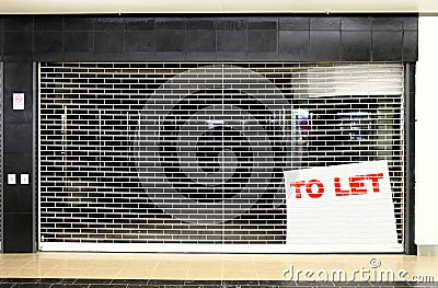 Closed store business space with to let sign Stock Photo