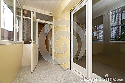 Closed terrace with double glass partition and white aluminum, ropes to hang clothes and terrazzo floors Stock Photo