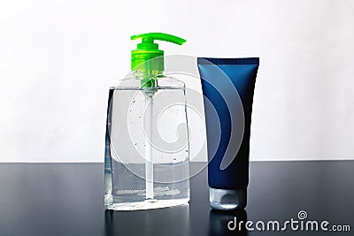 Closed tube with cream and bottle soap on wooden table Stock Photo