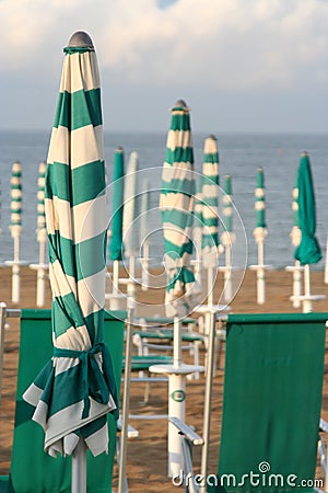 Closed umbrellas on the beach Stock Photo