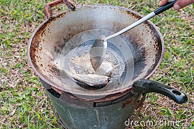 Closed up fried fish on stove, thai local life Stock Photo