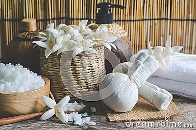 Closed up herbal massage compress with spa salt, fragrance flower, soft white towel, and aroma gel in spa shop Stock Photo