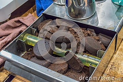 Closed up lumps of coffee grind filled on metal knock box Stock Photo