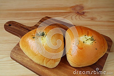 Closed up a pair of savory buns on wooden tray served on wooden table Stock Photo