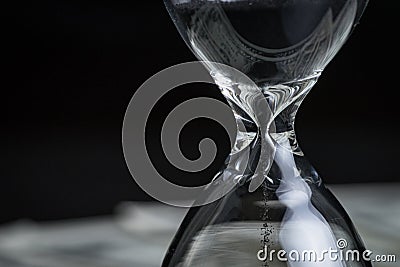 Closed up of sandglass or hourglass with reflection of US dollar Stock Photo