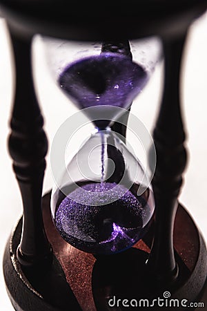 Closed up of sandglass or hourglass with violet, purple sand Stock Photo