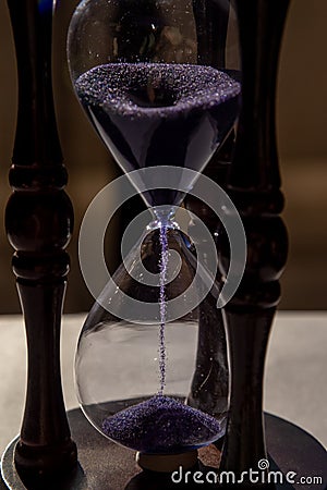 Closed up of sandglass or hourglass with violet, purple sand Stock Photo