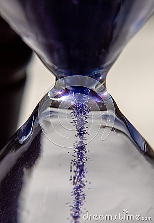 Closed up of sandglass or hourglass with violet, purple sand Stock Photo