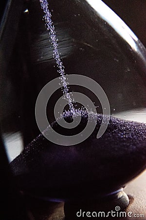 Closed up of sandglass or hourglass with violet, purple sand Stock Photo