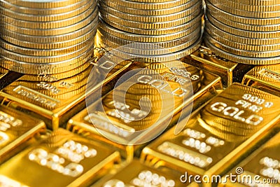 closed up shot of shiny gold bars with stack of coins as business or financial investment and wealth concept Stock Photo