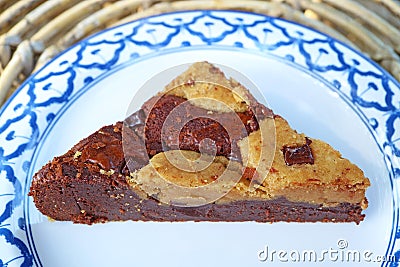 A slice of Mouthwatering Chocolate Brookie on a White Plate Stock Photo