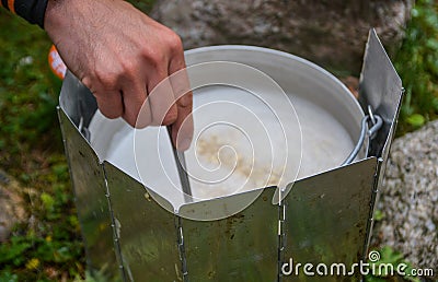 Closed view of hand stir porridge in a pan Stock Photo