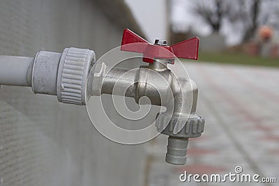 Closed water tap on the wall outdoor Stock Photo