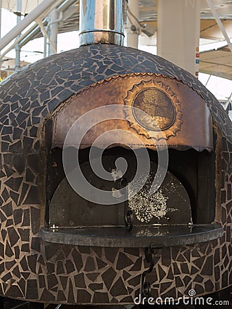 Closed Wood-burning Oven with Copper Sign Stock Photo