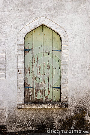 Closed wooden green shuttered arched window Editorial Stock Photo