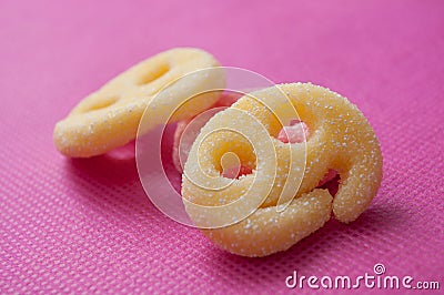 Acidulous candies in shaped smiley on pink background Stock Photo