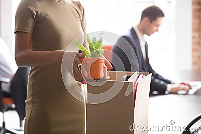 Closeup african female holding box with stuff having first workday Stock Photo