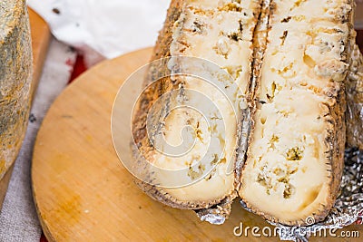 Closeup aged soft cheese on a served on wooden background. Dairy delicacies. Stock Photo