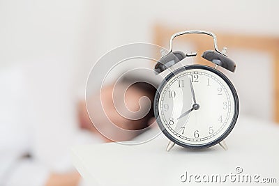 Closeup alarm clock and beautiful asian young woman in morning Stock Photo