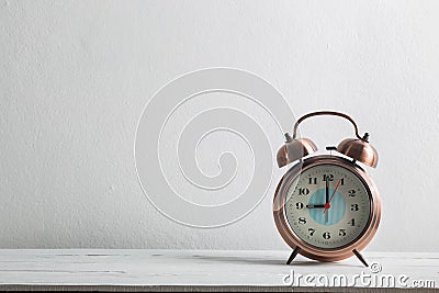 Closeup alarm clock for decorate show on white wood desk. Stock Photo