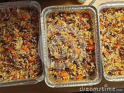 Closeup of 3 aluminum trays full of cooked biryani ready to go into the freezer for meal plan Stock Photo