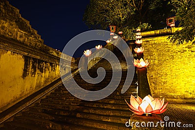 Closeup ancient architectural building with Buddhism garland flowers a night Stock Photo