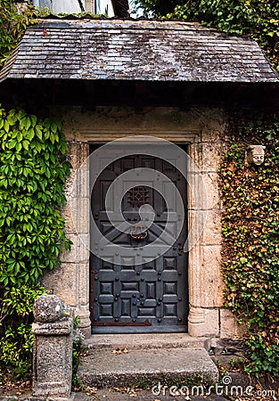 Closeup ancient entrance with vintage metal door Stock Photo
