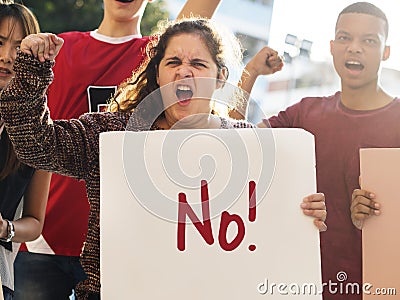 Closeup of angry teen girl protesting demonstration holding posters antiwar justice peace concept Stock Photo