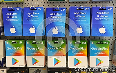 Closeup of Apple app store iTunes and Google Play voucher gift Cards in a row in shelf of german shop Editorial Stock Photo