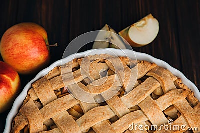 Closeup apple pie in blue form on a dark wooden background. Ready pie Stock Photo