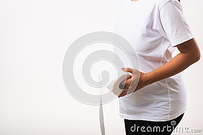 Woman diarrhea constipation holding tissue toilet paper roll on hand she crotch lower abdomen Stock Photo