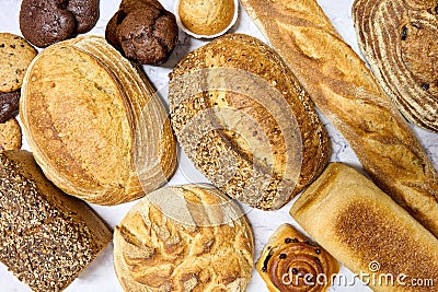 Closeup of an assortment of freshly baked bread on a marble table Stock Photo