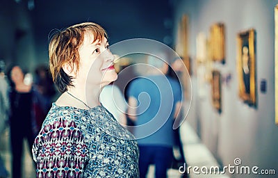Closeup on attentive senior woman visiting museum and enjoying a Stock Photo