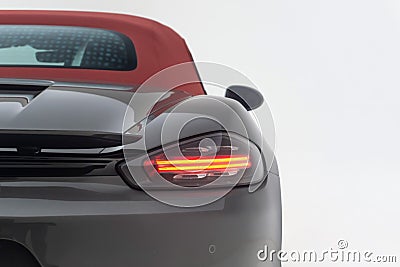 Closeup of a back of a luxurious Ferrari car parked against a plain white background. Editorial Stock Photo