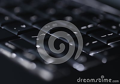Closeup of backlit computer laptop keyboard selective focus on question mark key ideal for technology support night hacker Stock Photo