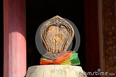 Closeup of Bai Sema or Sacred Boundary Stone in front of the Old Ordination Hall of Wat Chomphuwek Buddhist Temple in Thailand Stock Photo