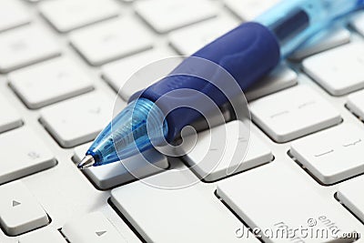 Closeup of a ballpoint pen on a keyboard Stock Photo