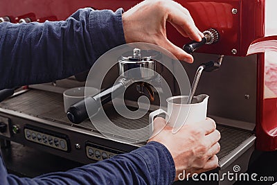 Closeup of barmen hand steaming milk in professional coffee machine Stock Photo