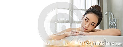 Closeup beautiful asian young woman lying down soke in bath tub. Stock Photo