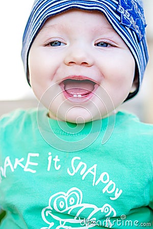 Closeup of beautiful happy baby with blue eyes Stock Photo