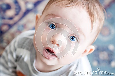 Closeup of beautiful happy baby with blue eyes Stock Photo