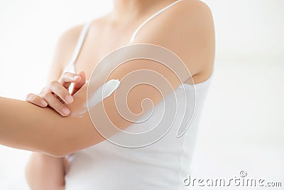 Closeup beautiful young asian woman smile applying sunscreen cream lotion on skin care at bedroom Stock Photo