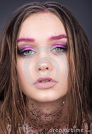 Closeup beauty portrait of beautiful girl teenager. Bright makeup with glitter Stock Photo