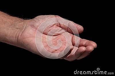 Closeup of a begging hand gesture on a black background Stock Photo