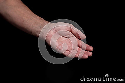 Closeup of a begging hand gesture on a black background Stock Photo