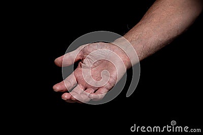 Closeup of a begging hand gesture on a black background Stock Photo